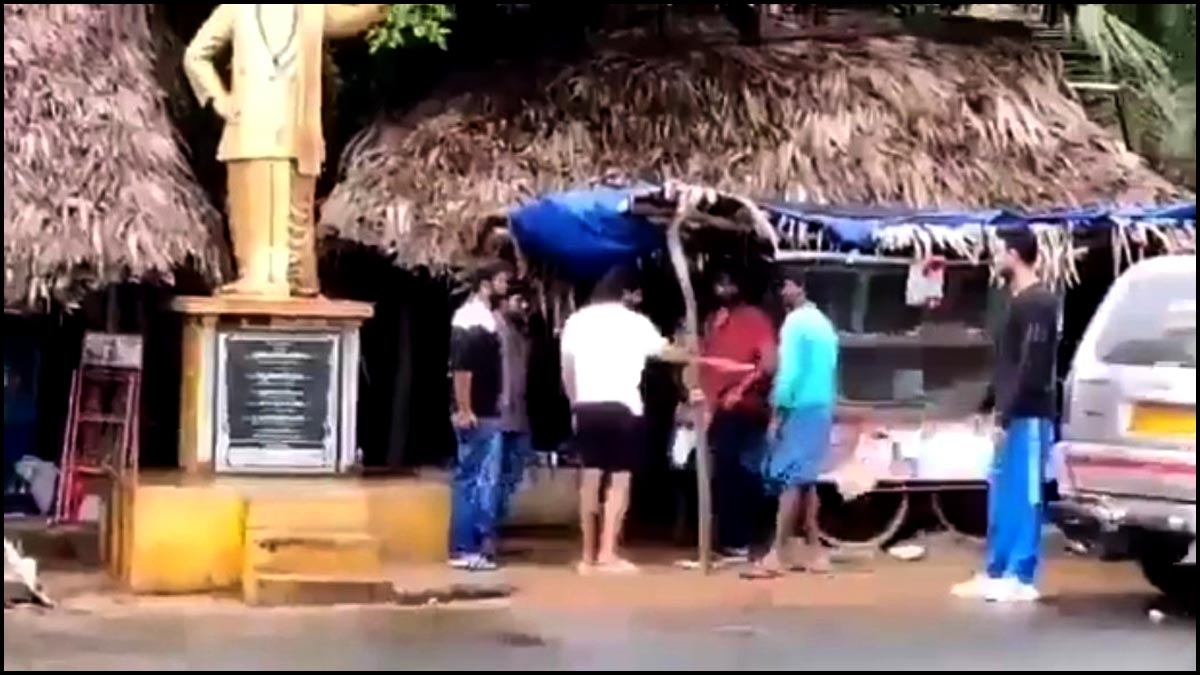 Do you understand this superstar eating from a roadside stall?